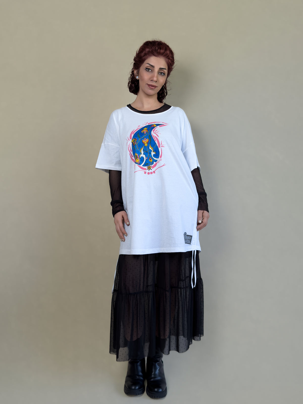 Detail view of Blue Paisley Drift by HANDLURIA, showing the loose silhouette and hand-painted paisley motif on the white tunic.