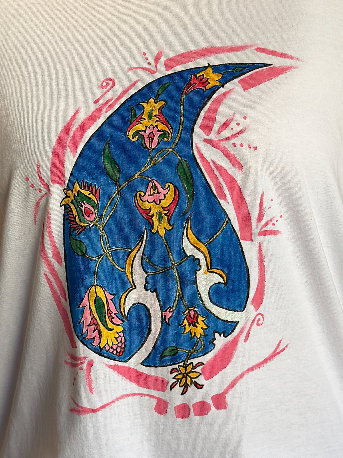 Close-up of the hand-painted blue paisley motif with pink and yellow floral details on Blue Paisley Drift by HANDLURIA.
