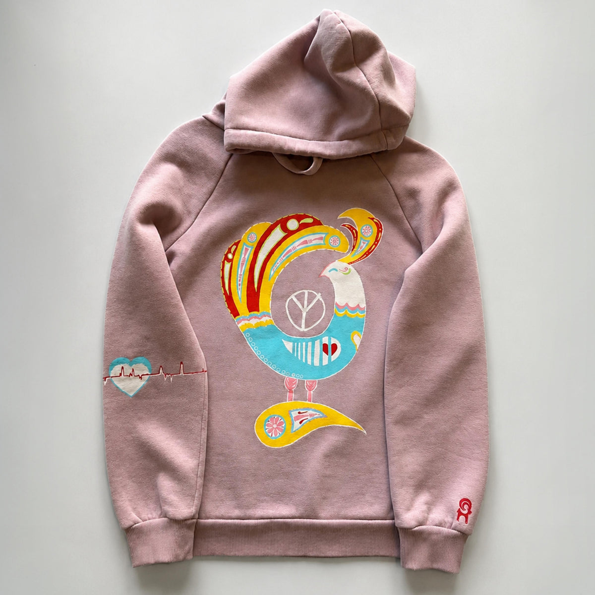 `HANDLURIA one-of-a-kind pink hoodie featuring a colorful hand-painted bird motif, heart details, and original wearable art.`