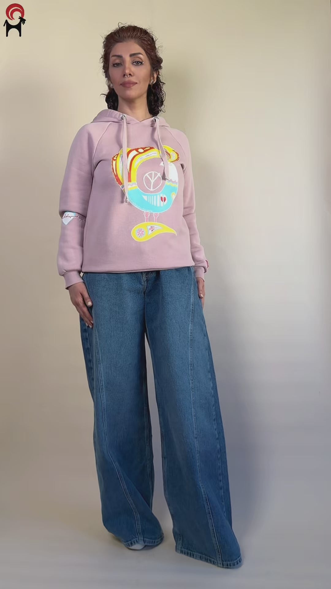 Northern Bird Song | Painted hand-painted blush-pink hoodie by HANDLURIA worn in motion.