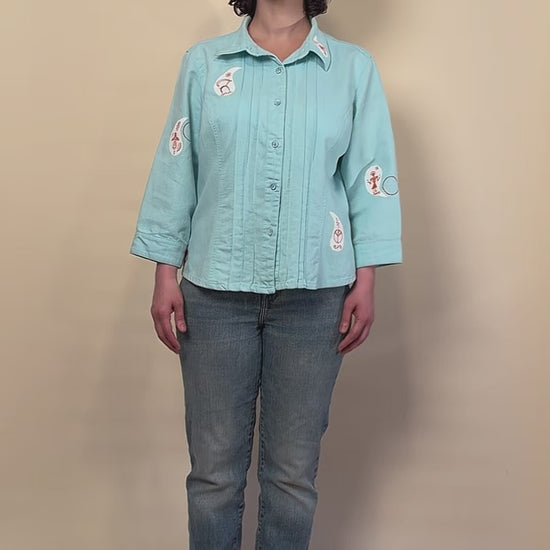 Before Borders | Under One Sun hand-painted turquoise shirt jacket by HANDLURIA worn in motion.