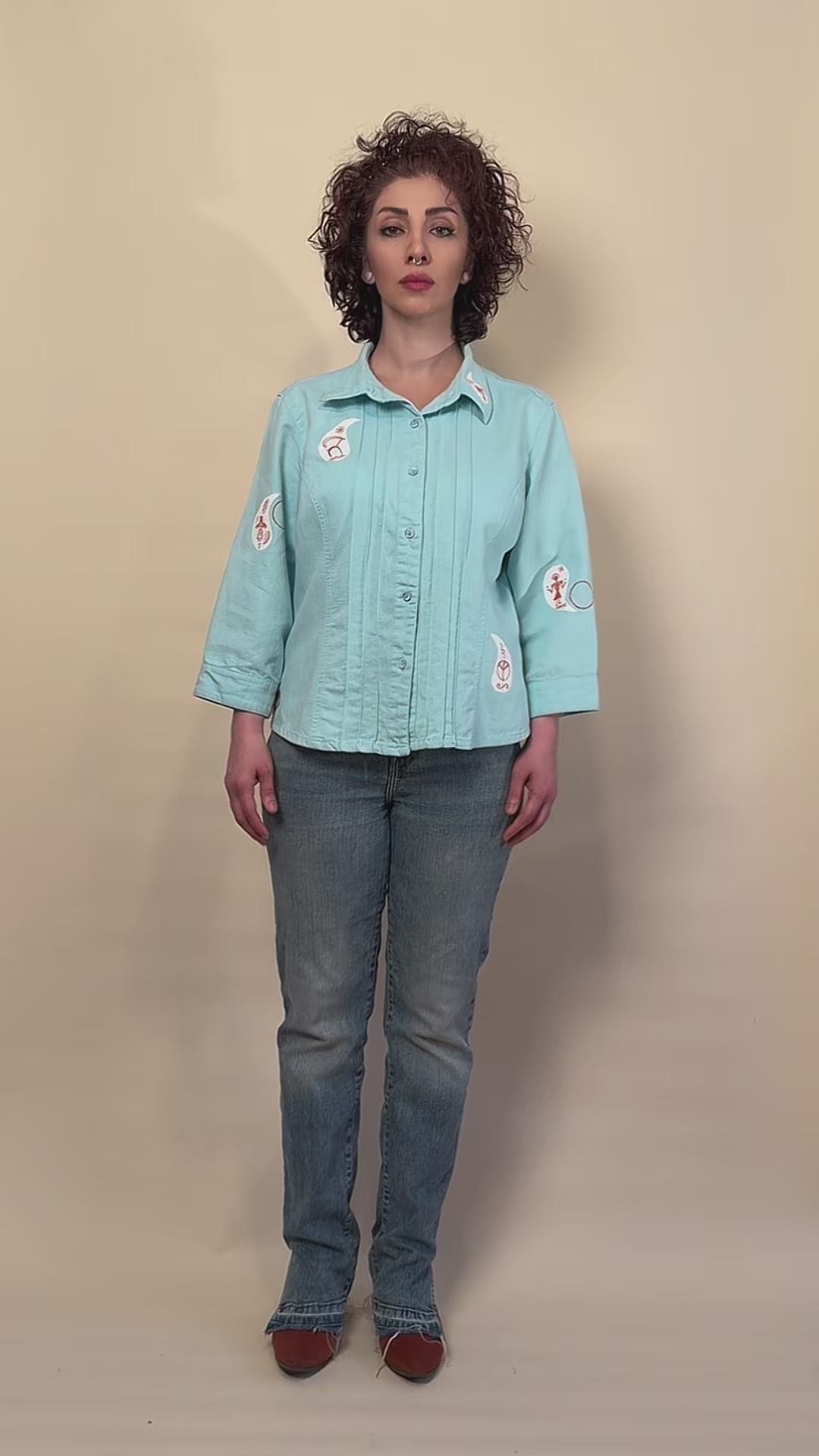 Before Borders | Under One Sun hand-painted turquoise shirt jacket by HANDLURIA worn in motion.