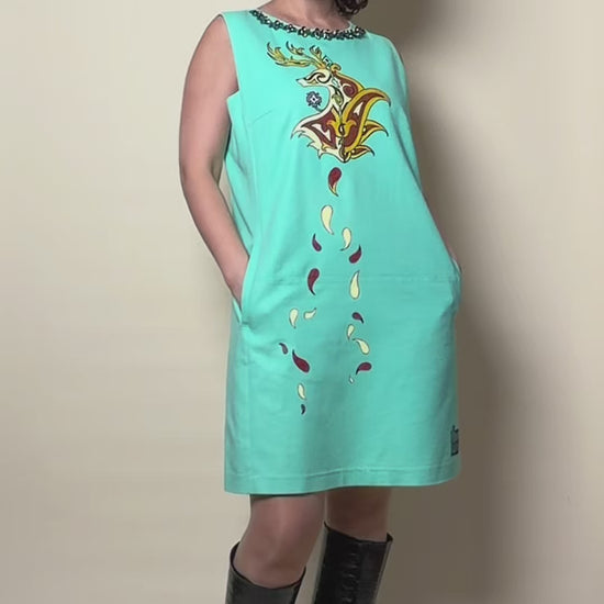 Fireborne Stag hand-painted turquoise dress by HANDLURIA worn in motion.