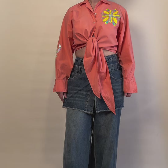 Songbird Bloom hand-painted coral tie-front shirt by HANDLURIA worn in motion.