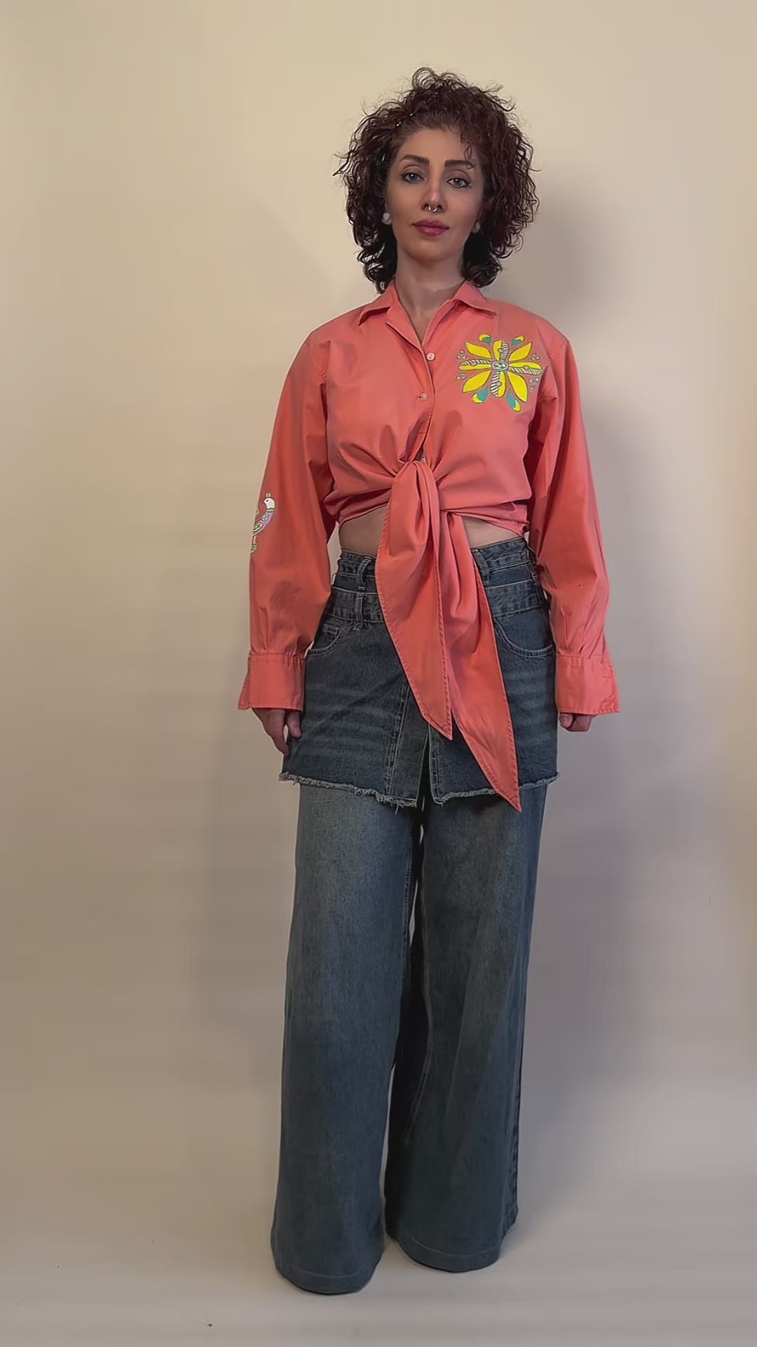 Songbird Bloom hand-painted coral tie-front shirt by HANDLURIA worn in motion.